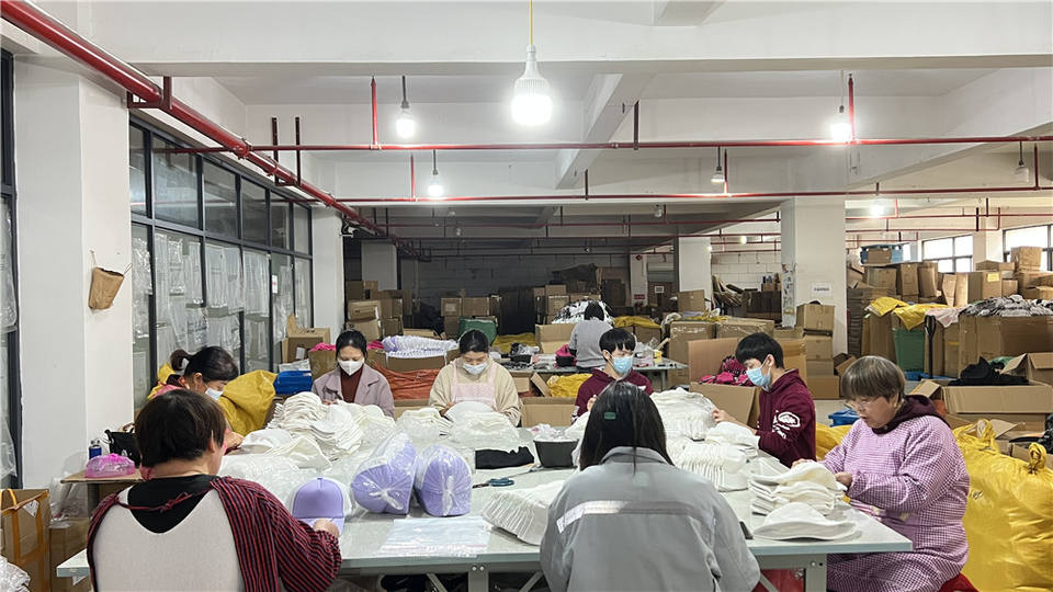 Workers sewing hats on the Hatazzle production floor