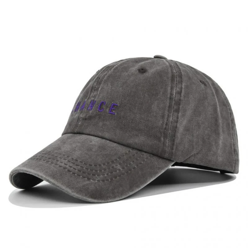 Side view of grey washed baseball cap with embroidered logo