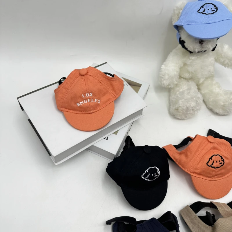 Orange and blue pet baseball caps with plush toys