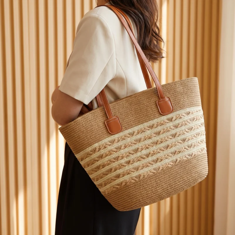 Woman carrying a striped straw tote bag on the shoulder