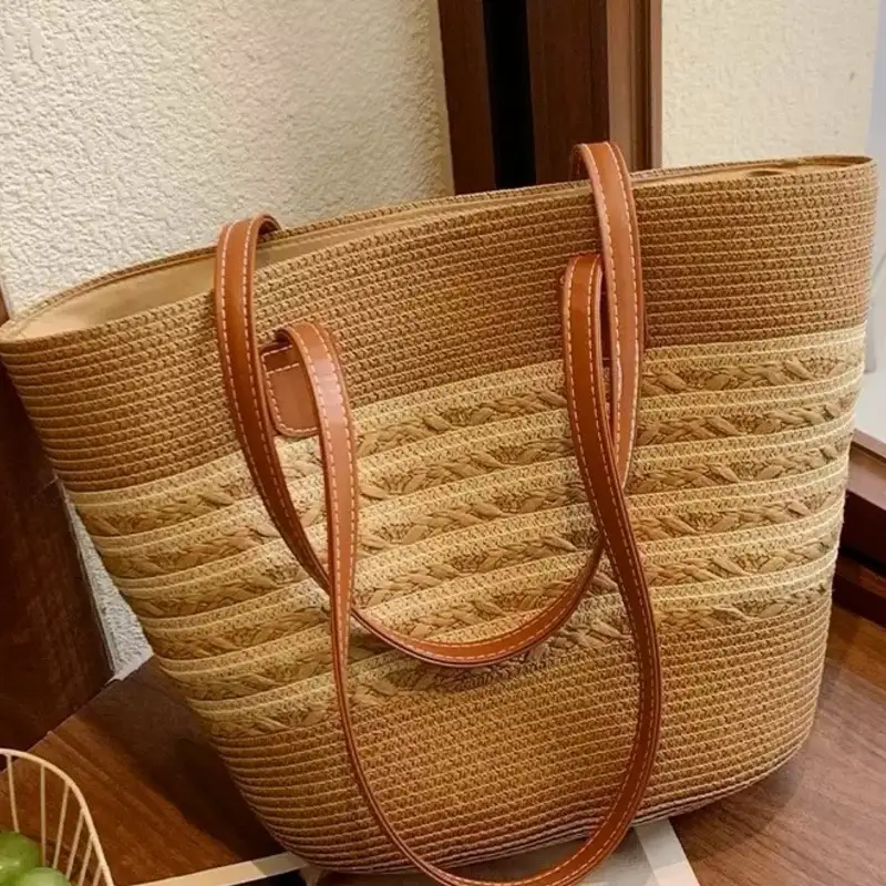 Large light brown woven straw beach bag standing upright